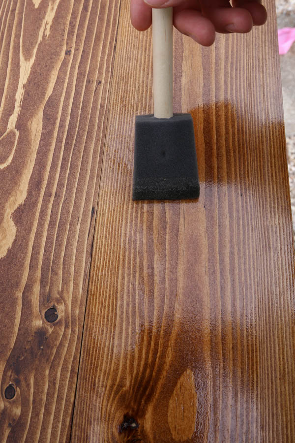 applying a second coat of polyurethane to wood