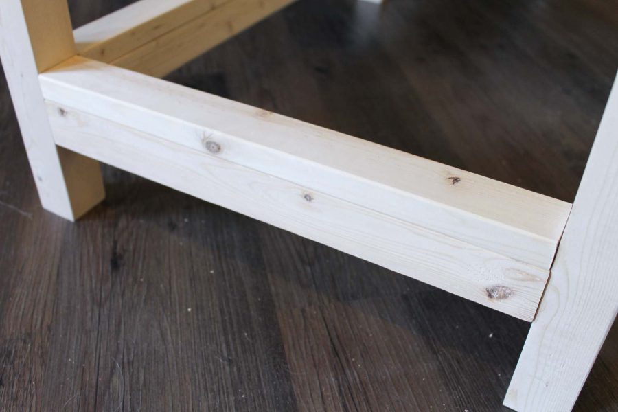 Assembling the bottom wood shelf of the bar cart