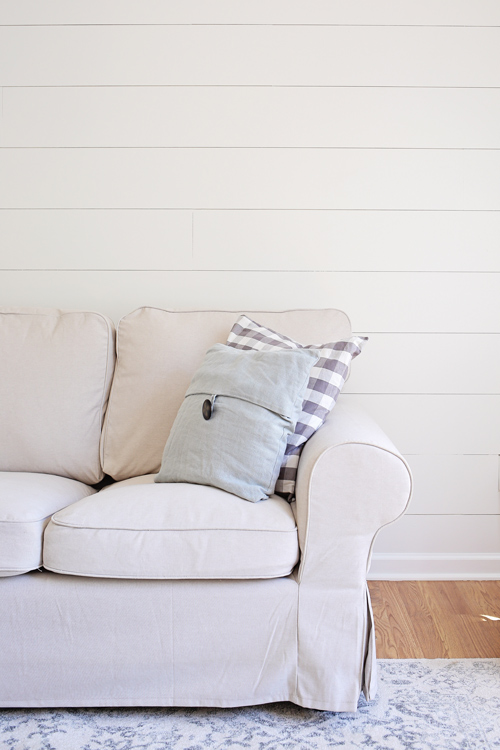 DIY Shiplap Accent Wall painted White Dove by Benjamin Moore in eggshell  in living room with couch