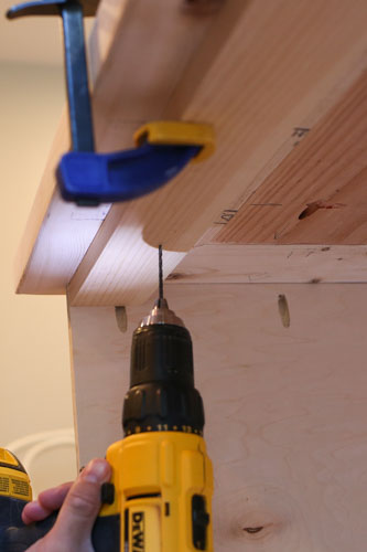 attaching DIY TV stand top to the base with drill and screws