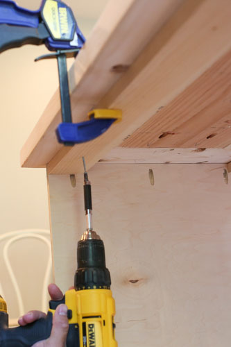 attaching DIY TV stand top to the base with drill and screws