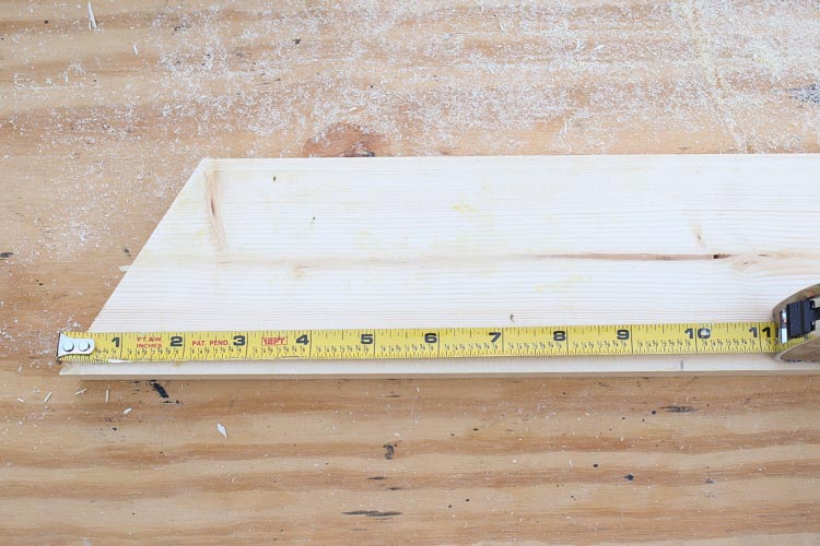Measuring base of diy wooden christmas tree with tape measure