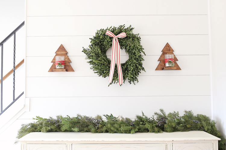DIY Wood Christmas Tree Mason Jar Sconces hanging on shiplap wall with boxwood Christmas wreath and Christmas decor