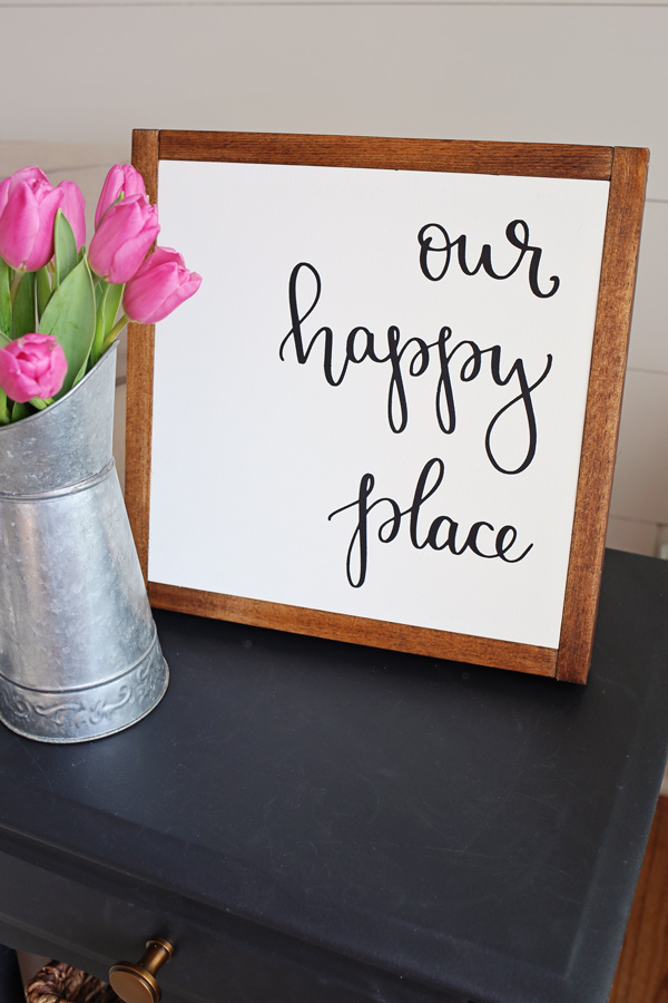 Our Happy Place DIY Wood Sign with pink tulips on black side table