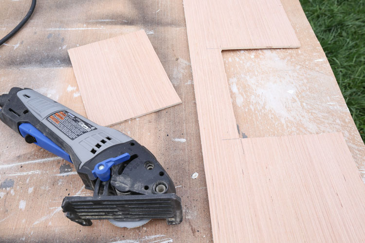 An opening cut out of shiplap board for ceiling vent and a dremel tool