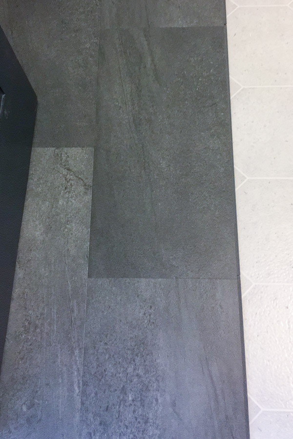 half covered bathroom floor with new luxury vinyl tile