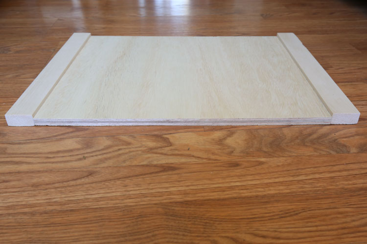 plywood side board with two 1x2 boards attached on each side