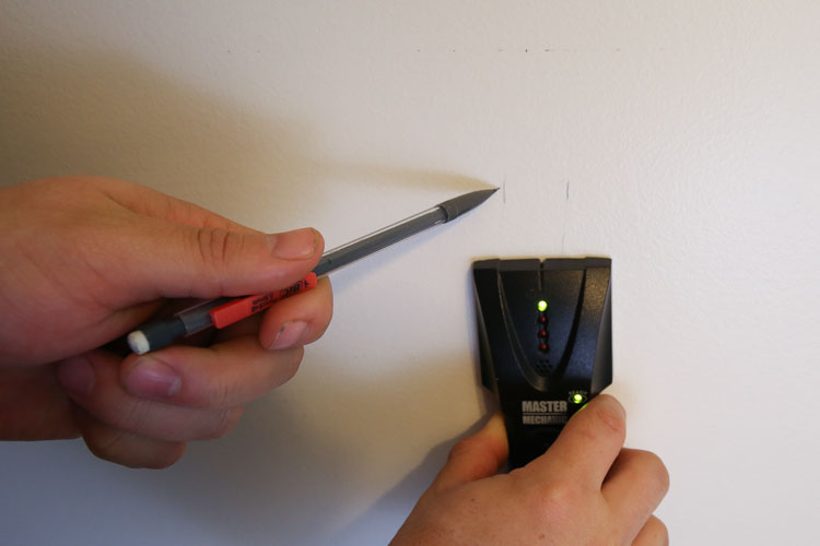 Use a studfinder and mark where the studs are on the wall