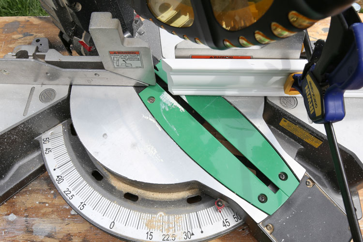 Moulding is cut at a 45 degree angle with a miter saw