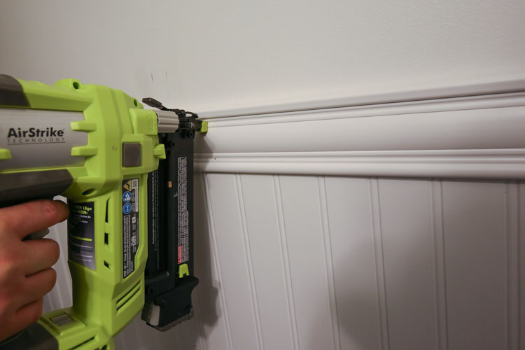 Attach the moulding to the wall with a brad nailer