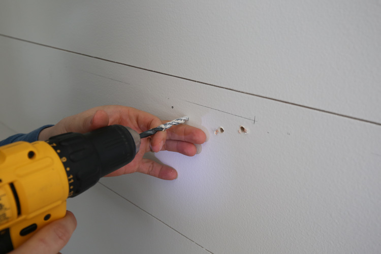 drilling pilot holes on wall for floating shelf brackets