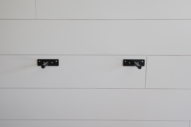 two heavy duty steel floating shelf brackets hung on the wall