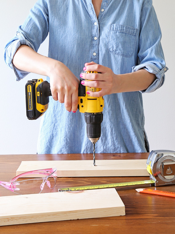 woman using a power drill which is a woodworking tool for beginners