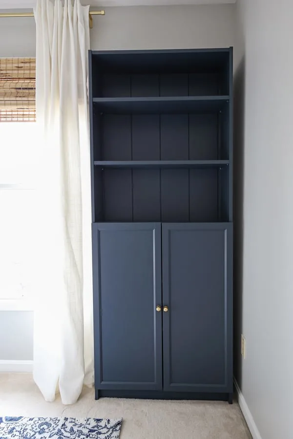 IKEA Billy bookcase hack with shiplap and painted navy blue in an office
