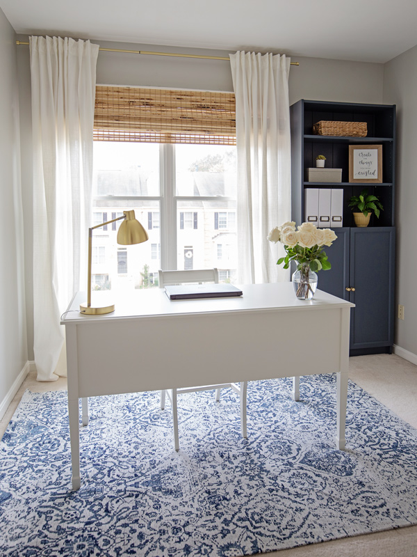 White desk in a navy and grey home office makeover