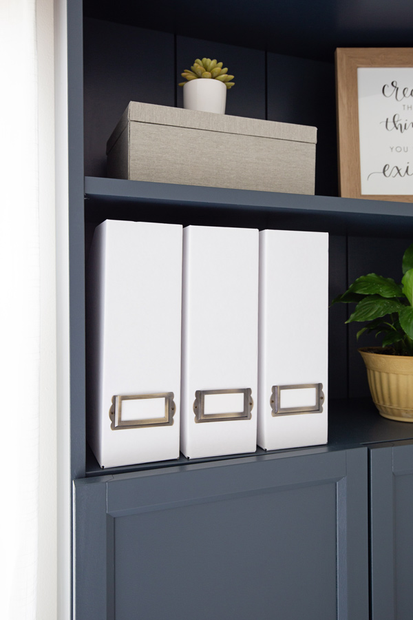 DIY magazine holders on bookshelf in office