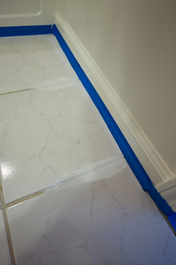 Priming edge of bathroom floor and tile grout lines