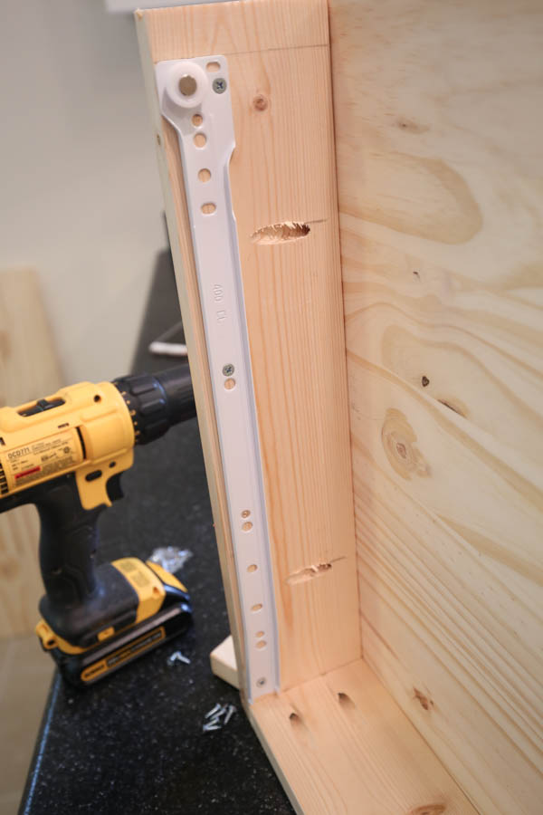 Attaching drawer slide on interior of makeup vanity