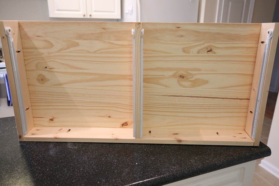 All four drawer slides attached to interior sides of makeup vanity