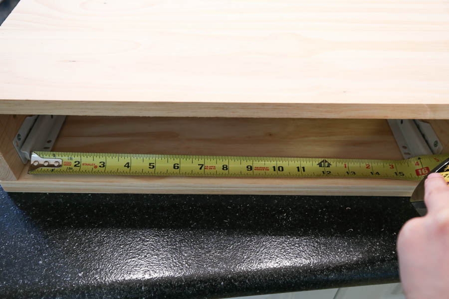 Measure distance between drawer slides with tape measure