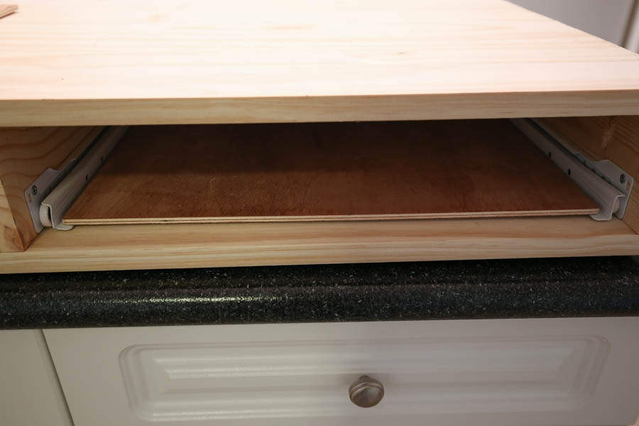 place plywood board between drawer slides to ensure a good fit