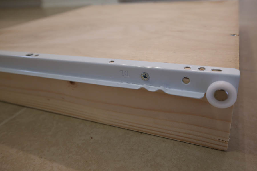 Side view of the DIY drawer box and drawer slide which is attached with screws