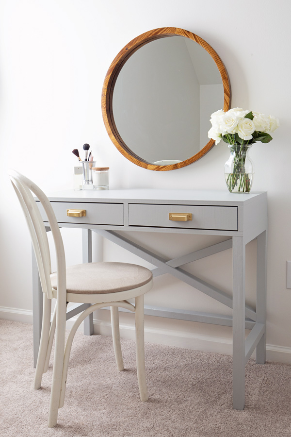 DIY makeup vanity painted light grey with chair and round wood mirror