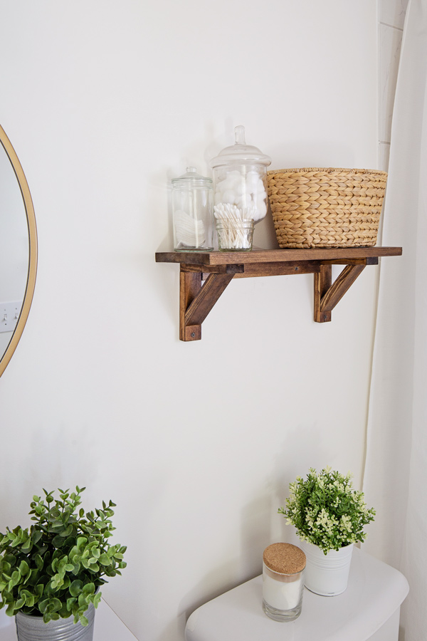 Wood floating shelf over toilet for extra bathroom storage