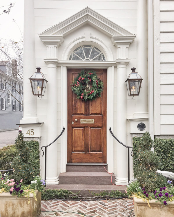 Christmas wreath with berries on wood door in Charleston for Christmas decor