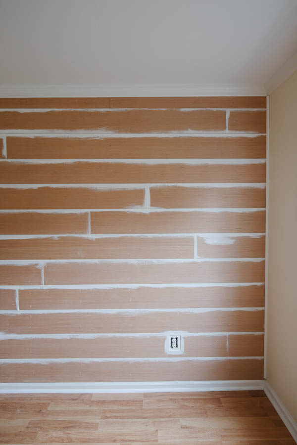 partially painted shiplap wall after shiplap installation