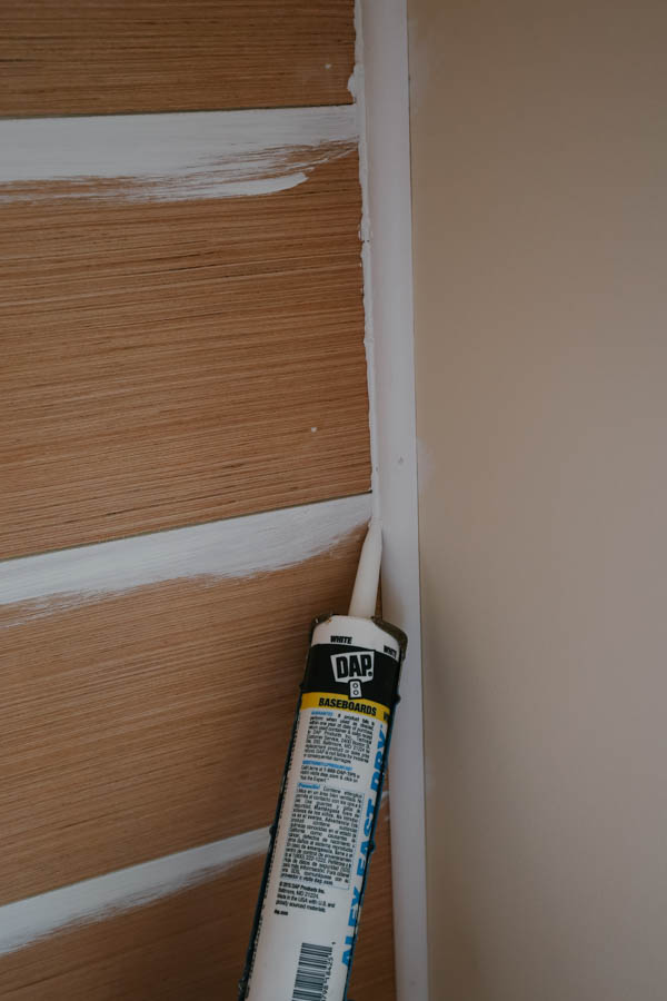 Caulking inside wall edge corner where shiplap meets the wall molding