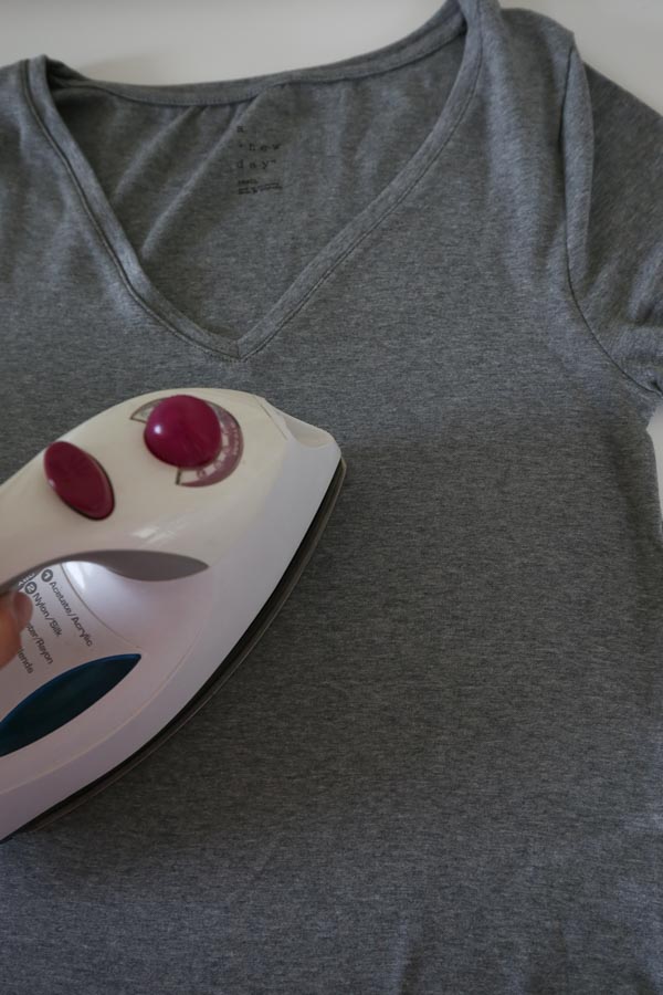 Prepare shirt for the heat transfer vinyl by ironing it and lay it out on flat surface