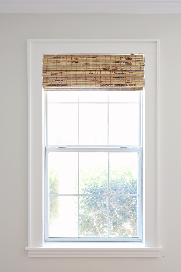 Painted DIY window trim with bamboo blinds