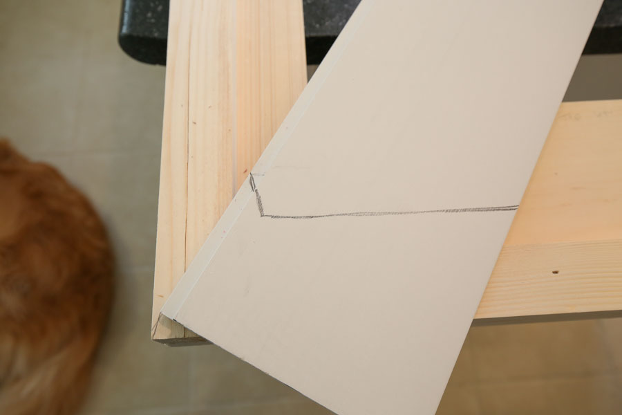 marking where to cut shiplap board for DIY barn door