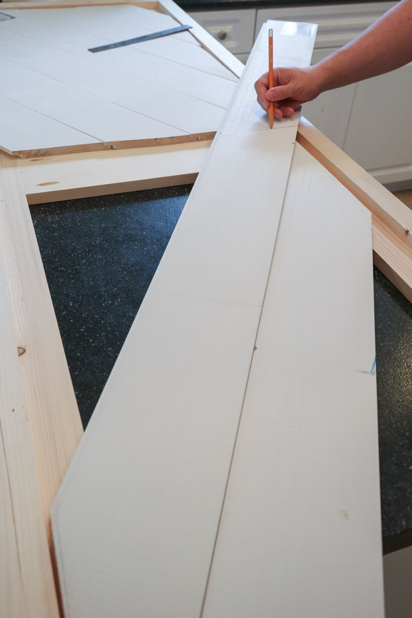 installing second shiplap board for barn door entertainment center DIY