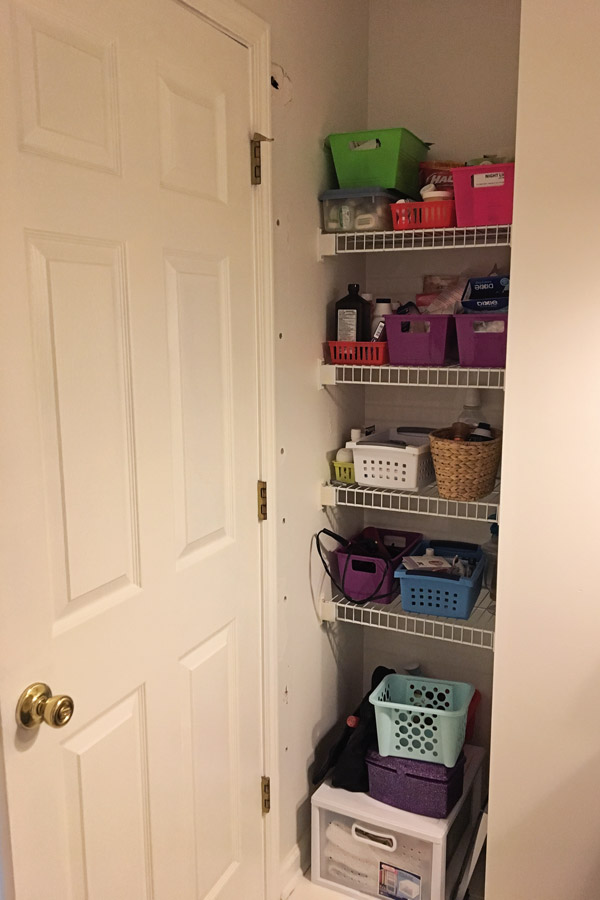 storage nook with shelves behind bathroom door before makeover