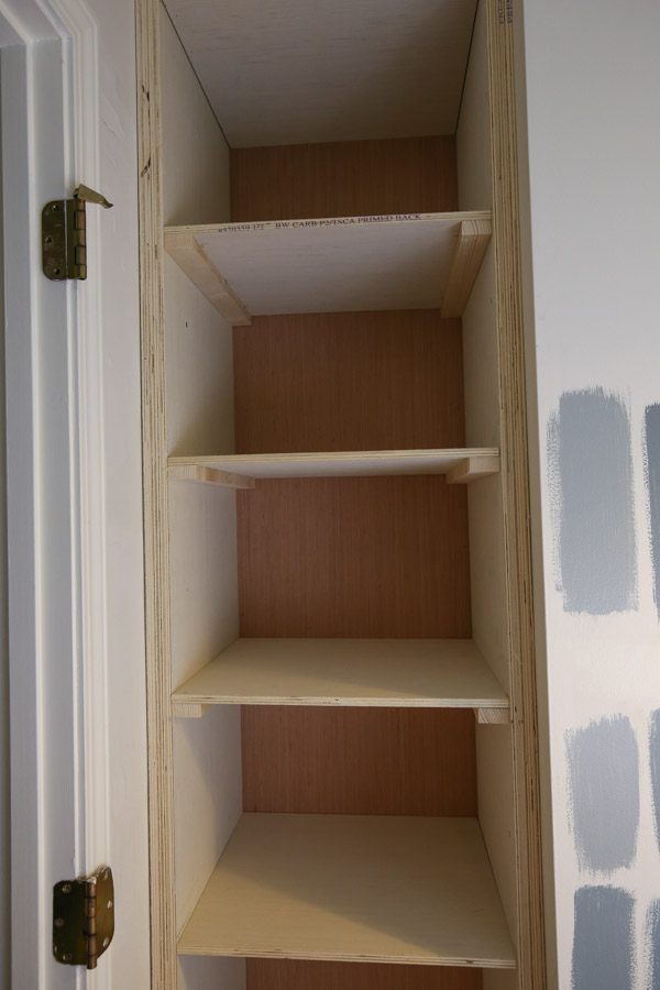 Add 1x2 wood braces under plywood shelves with brad nails