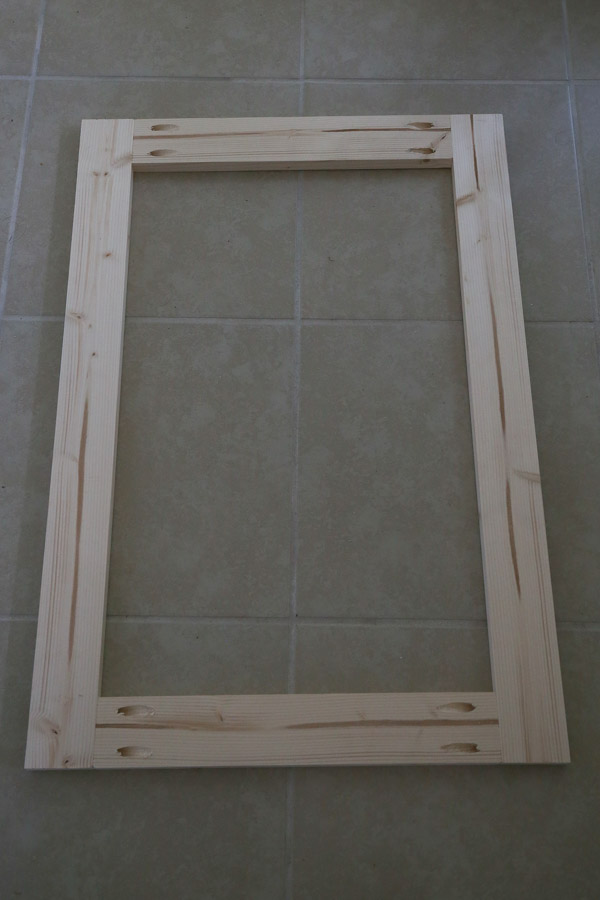 Build the door frame of the DIY built in cabinet door with 1x3s and attach with pocket holes and Kreg screws