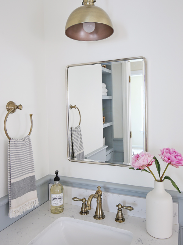 mixed metals in bathroom with mirror and sink facuet