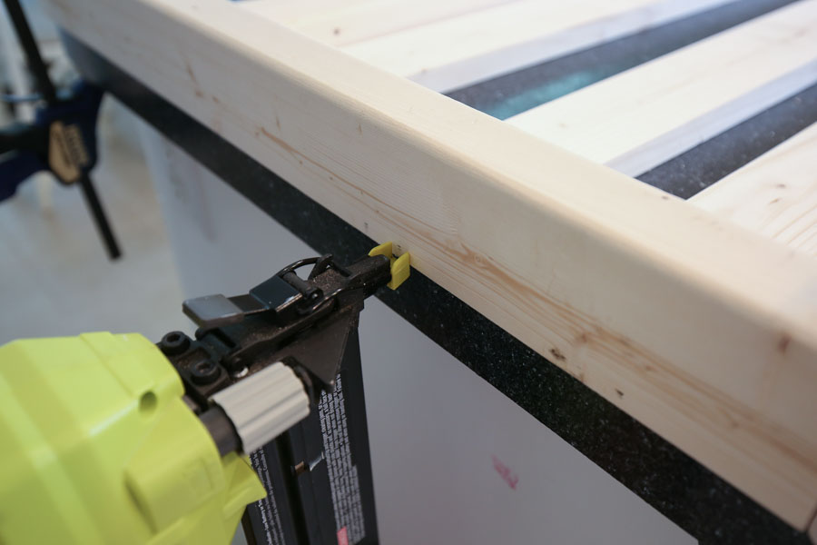 Add side slat boards to side frames with brad nailer and brad nails