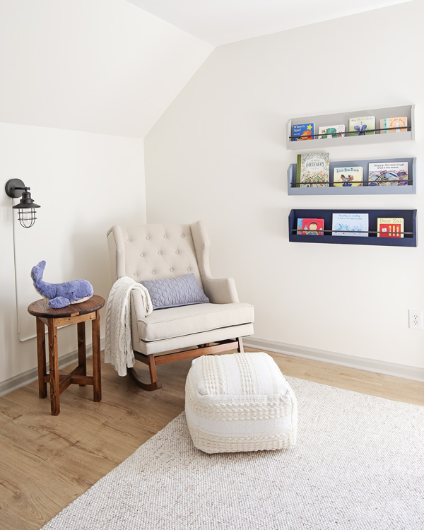 nursery reading nook with rocker and bookshelves on wall