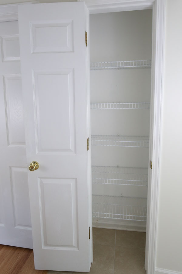 wire shelves in pantry before makeover with new shelves