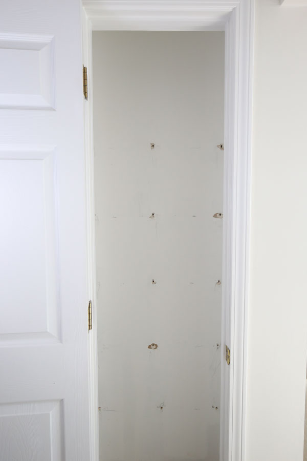 wire shelving and anchors removed from pantry wall
