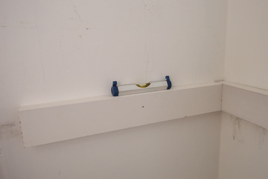use a mini level for pantry shelf side wall support boards