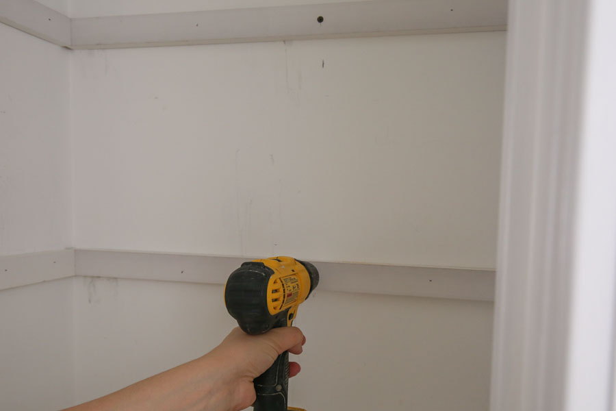 secure DIY pantry shelves support boards into pantry wall stud with a drill and screw