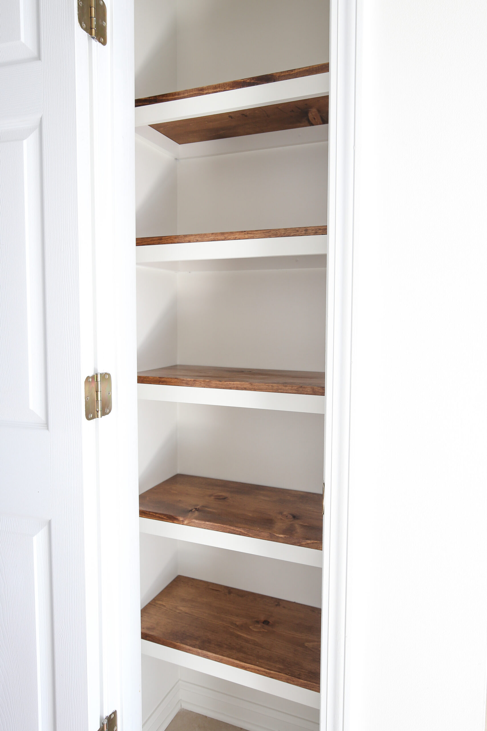 DIY Pantry Shelves with stained wood shelves and painted white trim