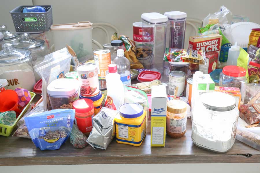 all pantry items removed from pantry and placed on kitchen table