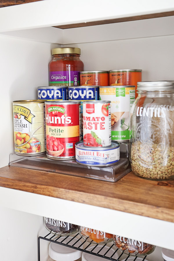 tiered pantry shelf with canned goods