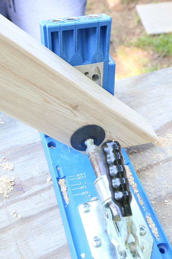 Use a Kreg Jig and add one pocket hole to angled short board