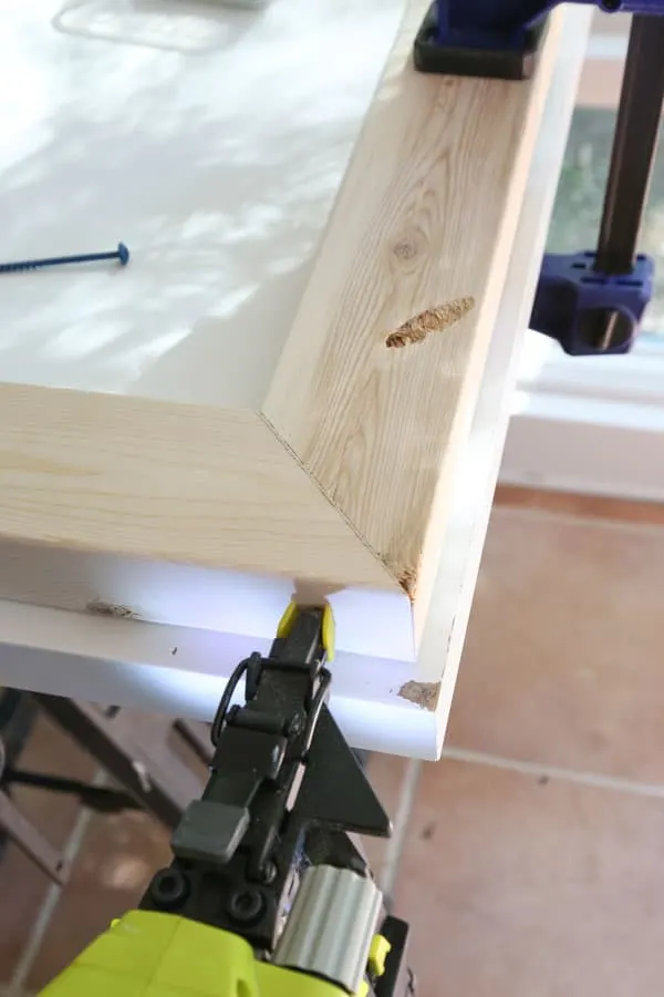 Use a brad nailer and 2" brad nails and nail through the two boards together